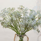 Close-up of artificial soft pale blue patrinia flowers showing fine clustered detail and subtle colour variation