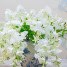 Close-up of artificial white sweet pea flowers showing soft petals and gentle colour detail