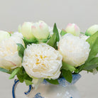 Close-up of artificial cream peony flower showing layered petals and soft colour detail