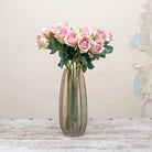Artificial dusky pink rose stems displayed together in a vase for styling purposes.