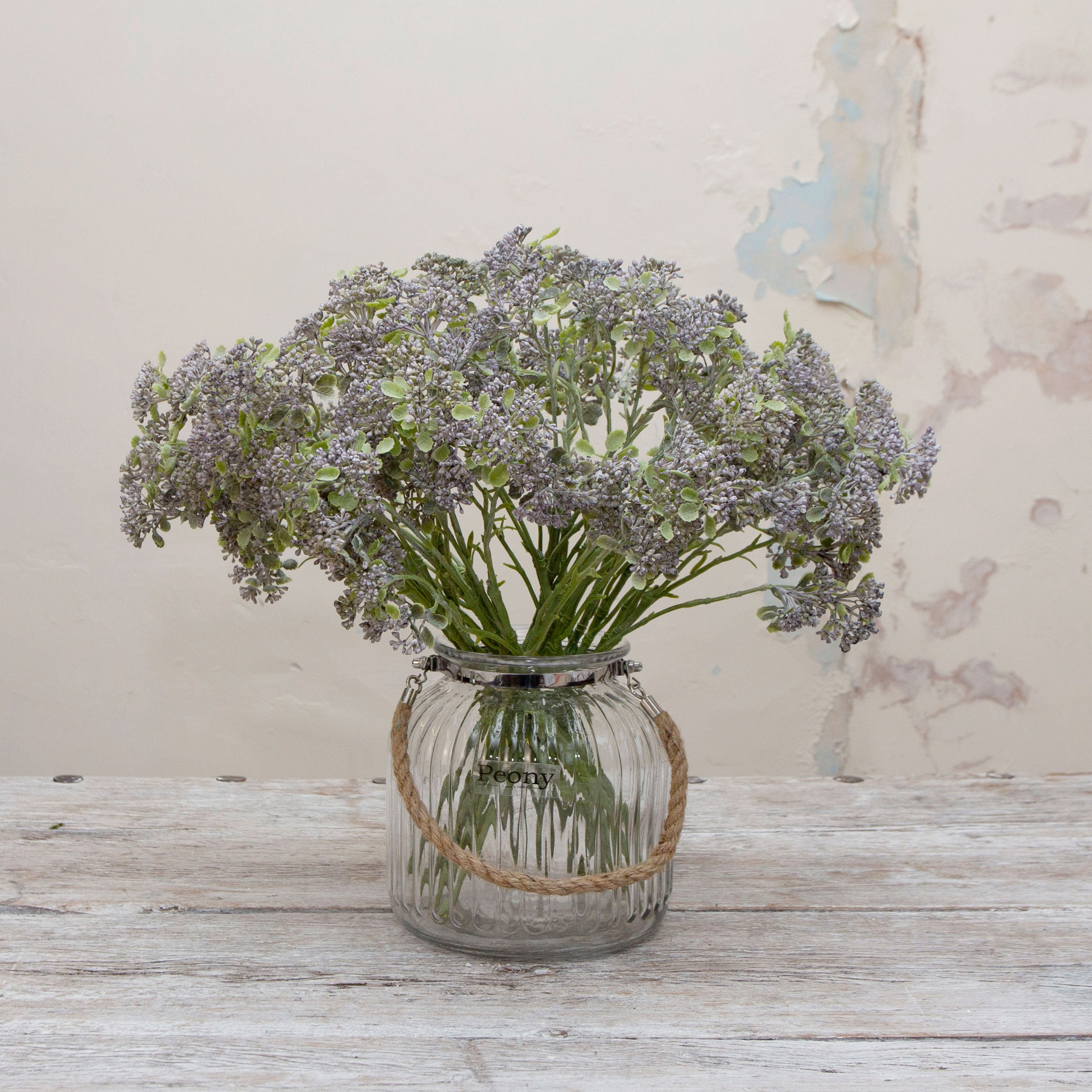 Artificial soft blue patrinia spray stems displayed together in a vase for styling purposes.