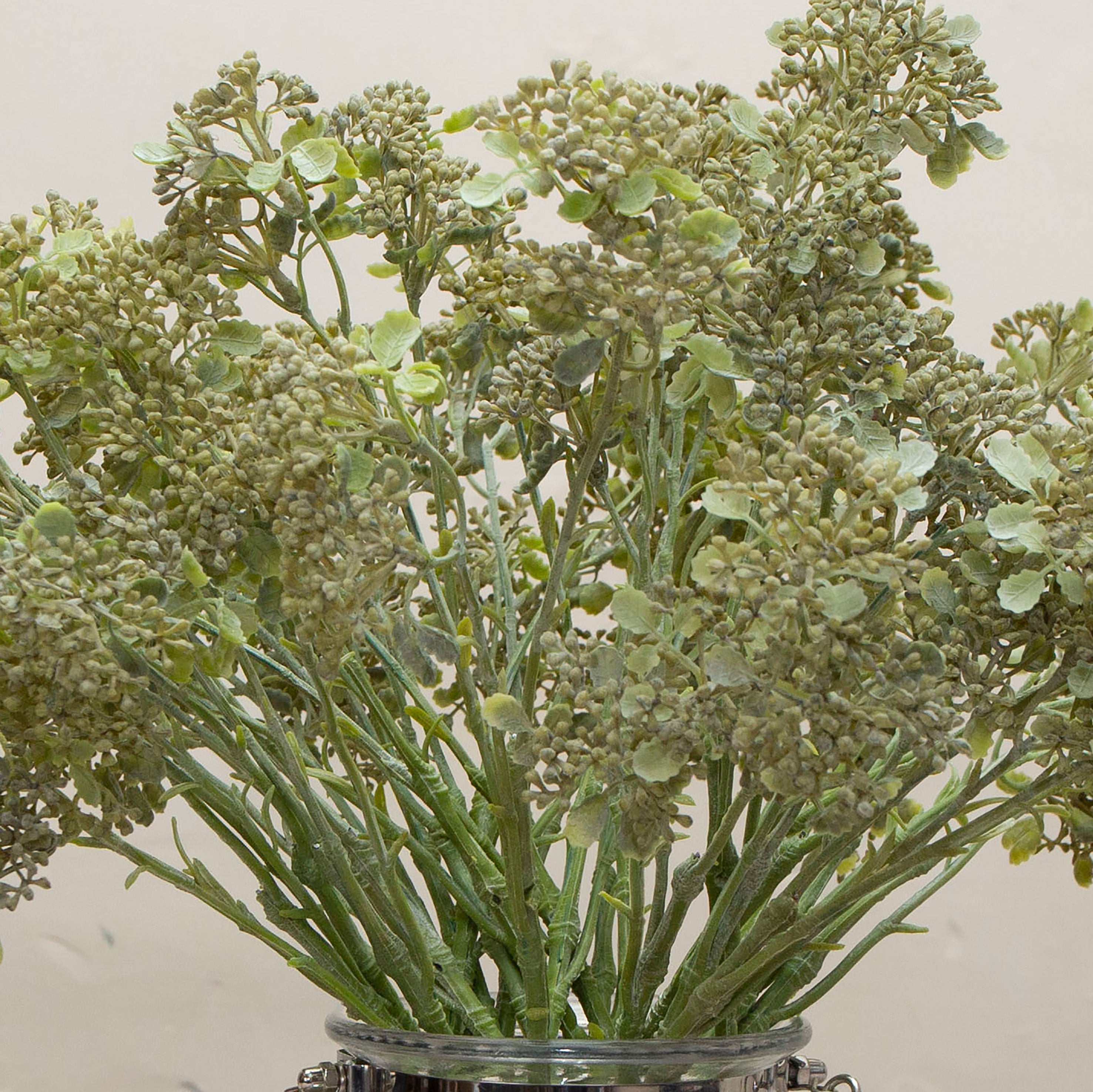 Close-up of artificial soft green patrinia flowers showing fine clustered detail and natural texture.