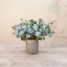 Artificial Eucalyptus Bunch Stems with soft blue-green rounded leaves and natural brown seed pods displayed in a textured metallic vase