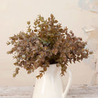Close up of Artificial Mini Eucalyptus Bunch Stem with dense muted green and warm brown foliage 