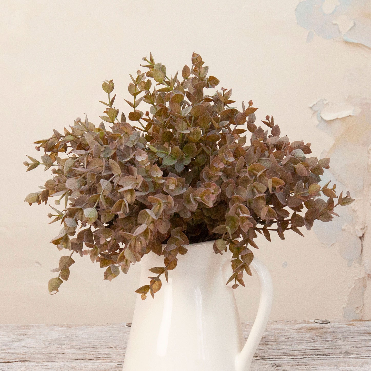Close up of Artificial Mini Eucalyptus Bunch Stem with dense muted green and warm brown foliage 