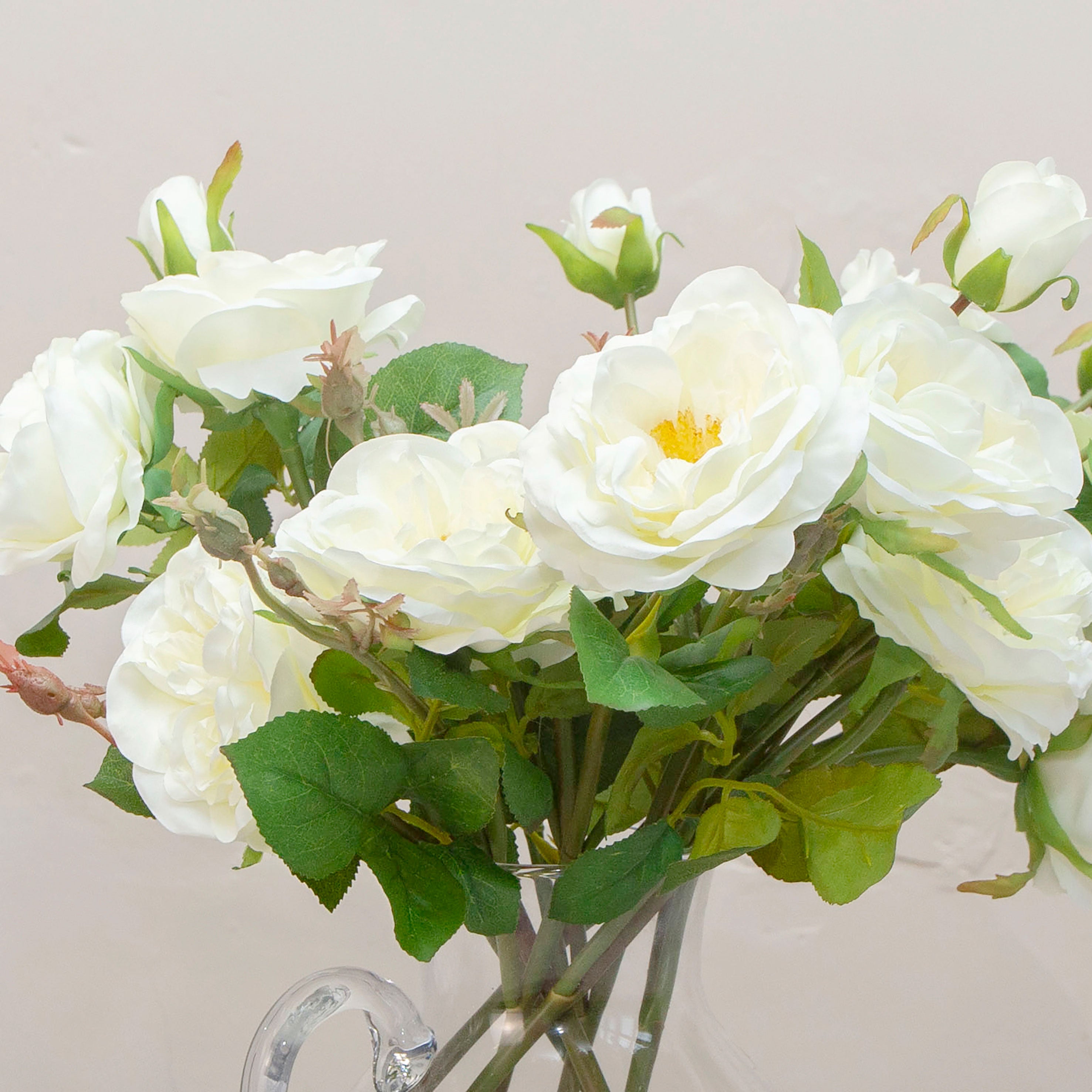 Close up of artificial bridal white old English rose stems