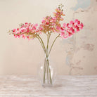 Artificial Phalaenopsis Orchid Stems with vibrant pink and soft blush blooms, detailed centres and delicate buds displayed in a clear glass vase