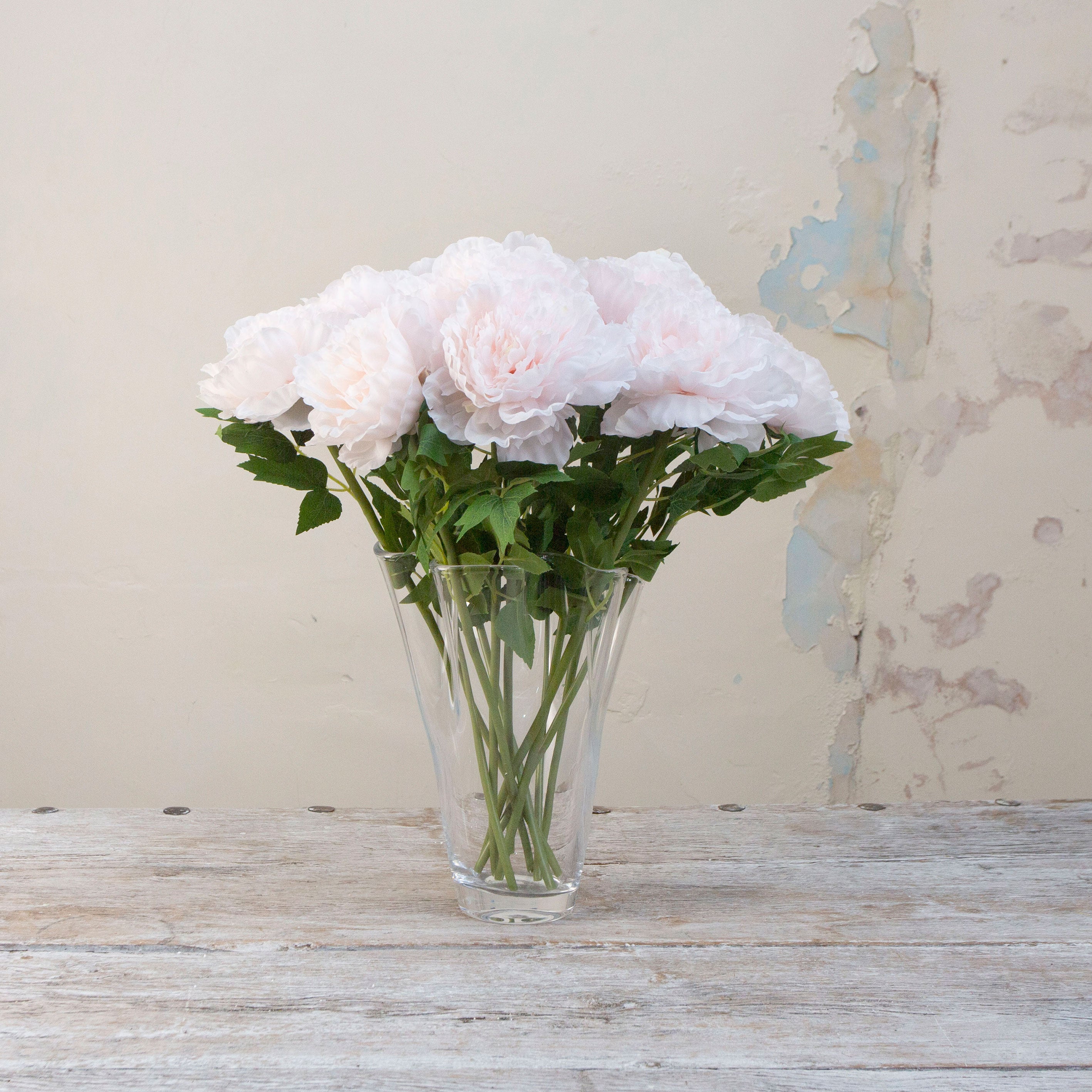 Artificial pale pink open Peony Stems displayed in a glass vase 