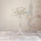 Artificial Foliage Stems with delicate white branching flowers and fine botanical detailing displayed in a clear glass bud vase