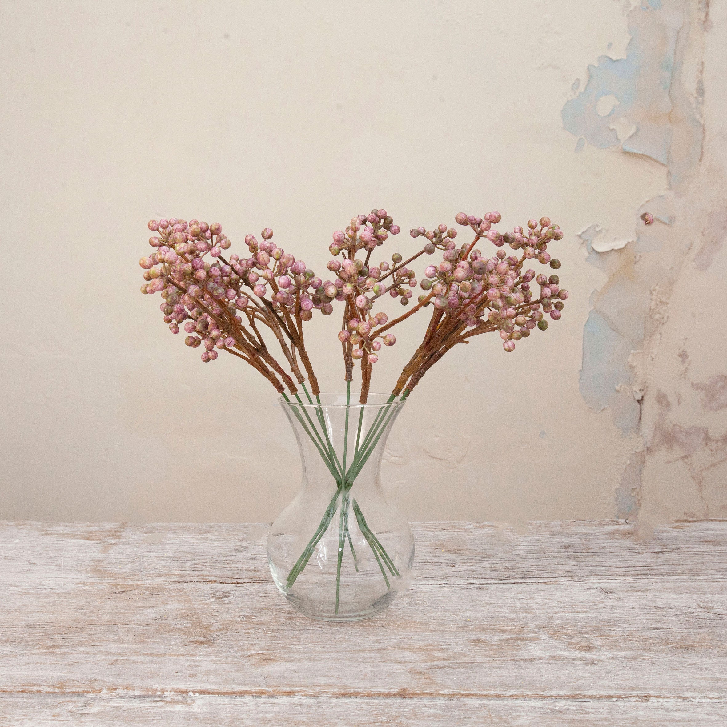 Artificial Berry Pick Stems with clusters of soft pink and mauve berries on natural brown branches displayed in a clear glass vase
