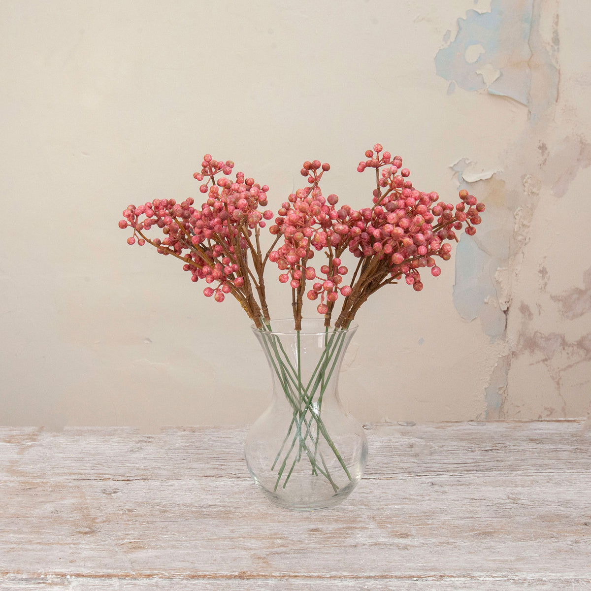 Artificial Berry Pick Stems with abundant clusters of vibrant pink berries on natural brown branches displayed in a clear glass vase