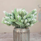 Close up of Artificial Pine Cone Fern Flocked Stems with frosted green fern foliage, soft white flocked tips and pine cone detailing displayed in a textured metallic vase