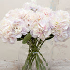 Close up of large headed artificial hydrangea stems with pale lilac and cream mixed petals 