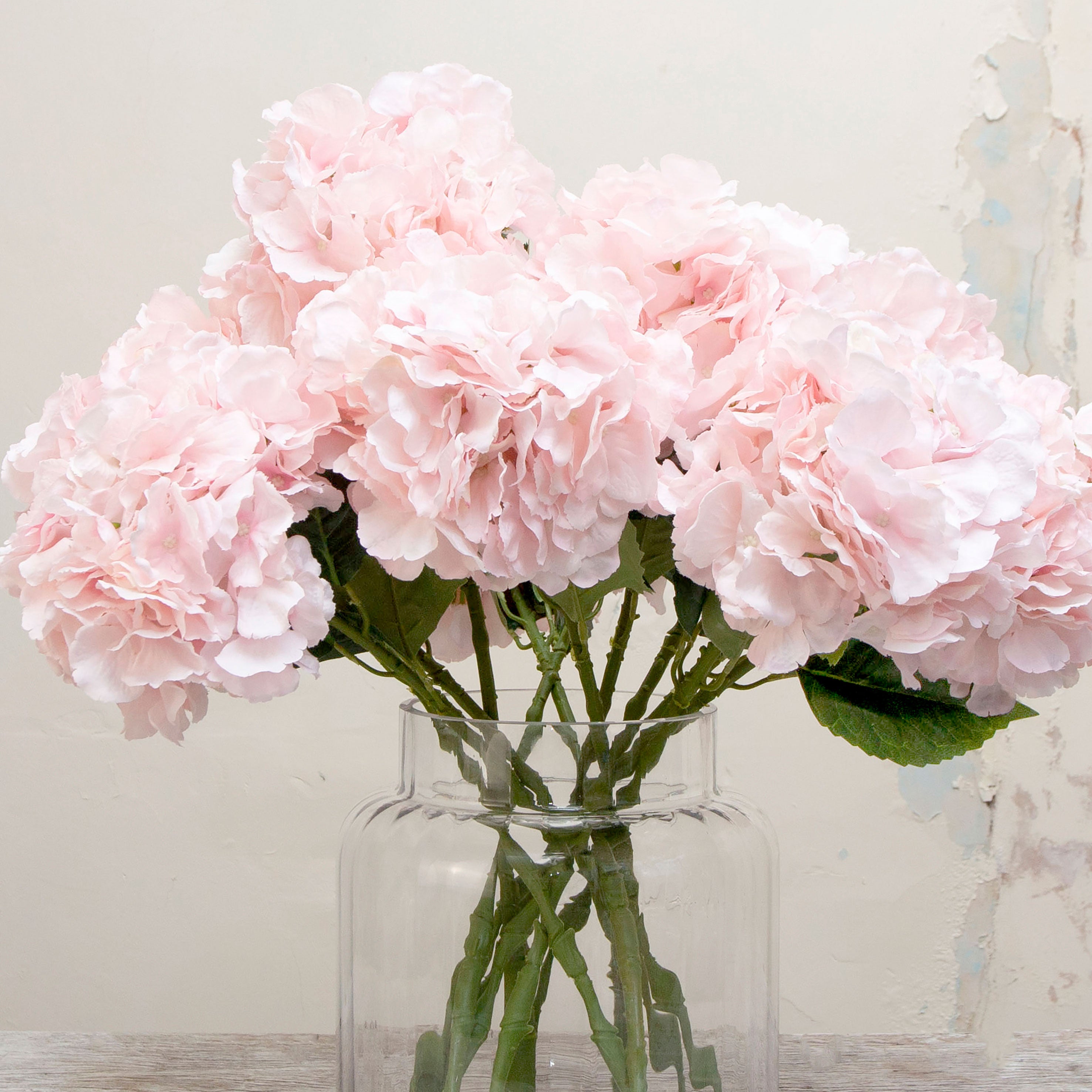 Close-up of artificial pale pink hydrangea flower, highlighting layered blush-pink petals, subtle tonal shading and realistic petal texture