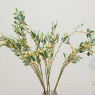 Close up of greenery stems with yellow seeds displayed