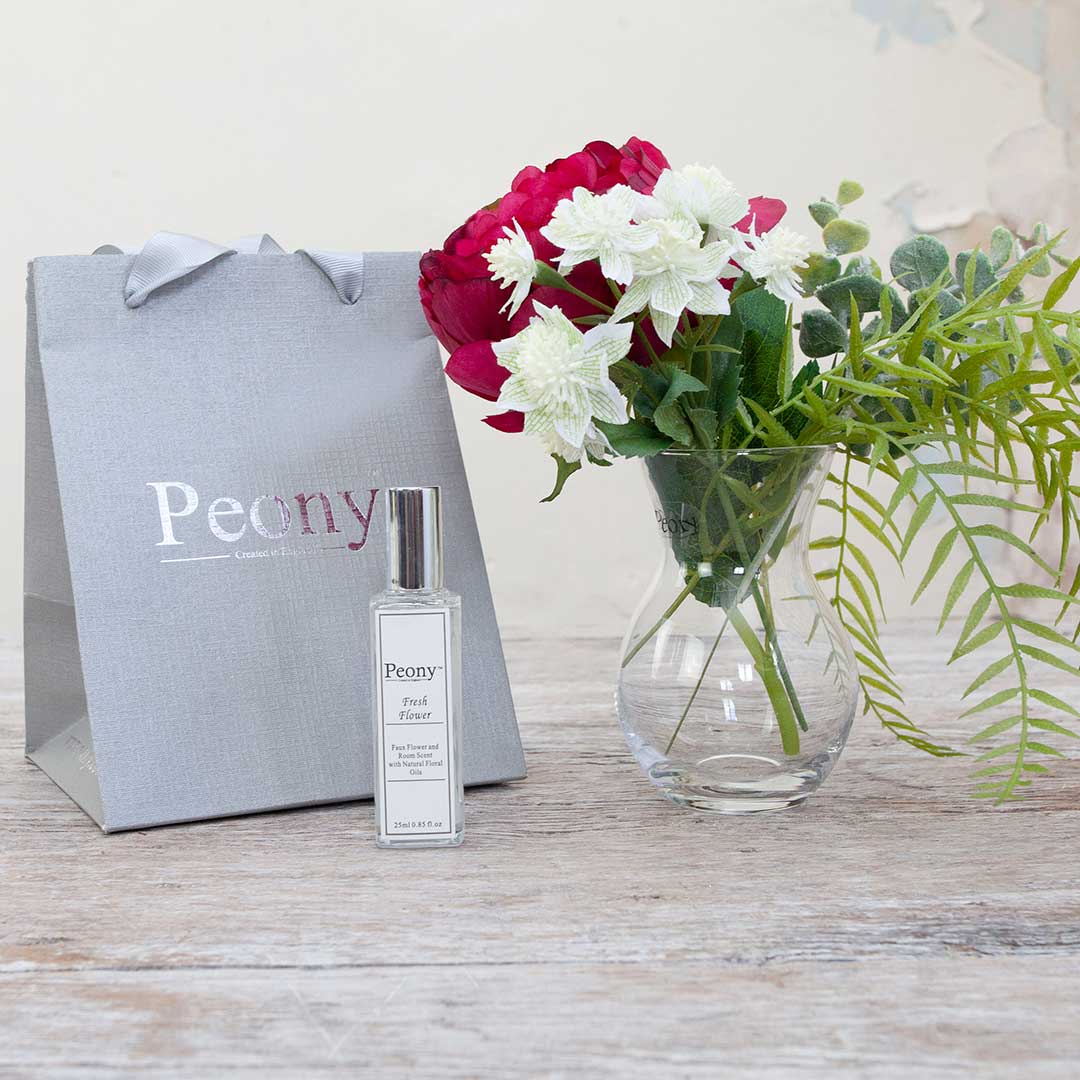 Pristina vase with Artificial magenta peony and foliage, presented with a peony gift bag and a 25ml Fresh Flower fragrance bottle.