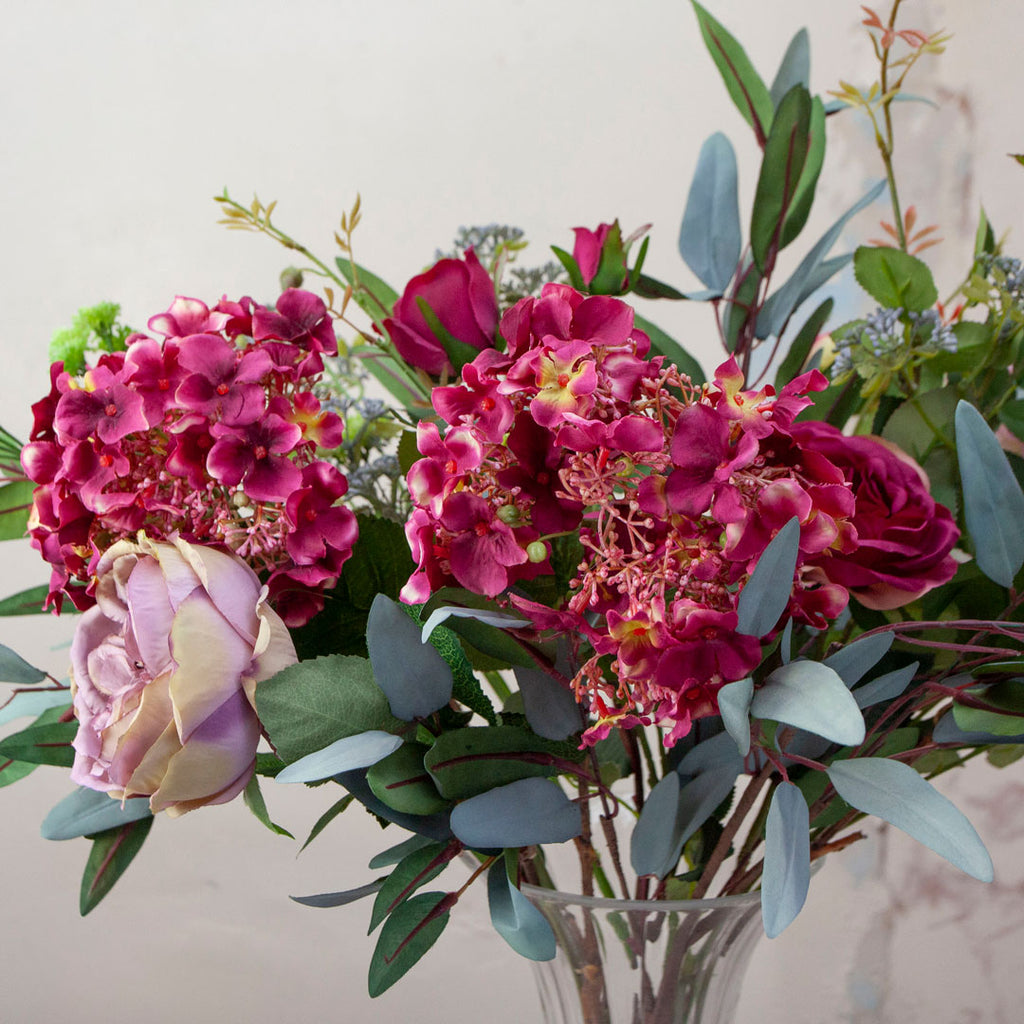 Close up of Magenta Roses, Hydrangea & Eucalyptus in a Grand Waisted Ridged Vase
