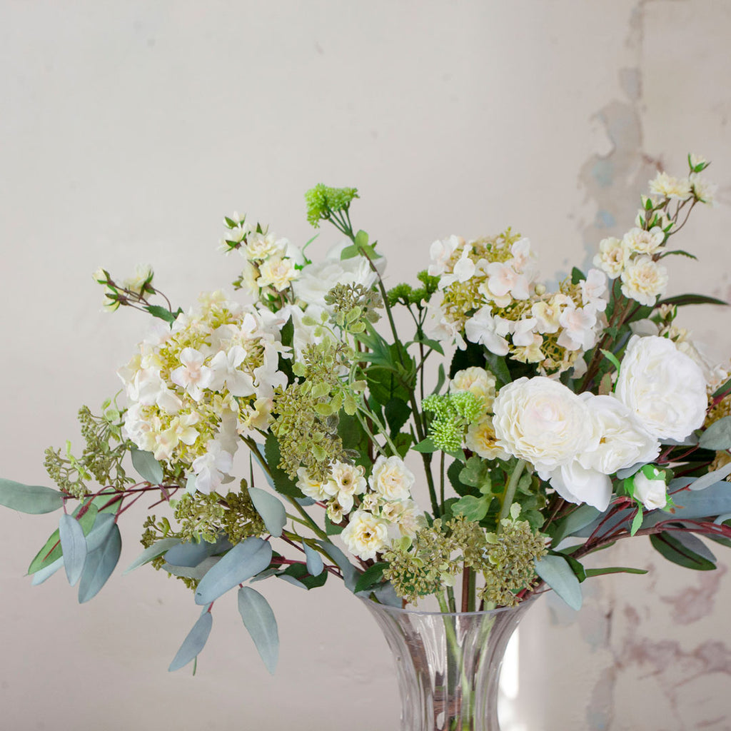 Close up of White Roses, Hydrangea & Eucalyptus in a Grand Waisted Ridged Vase