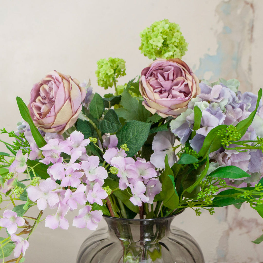 Close up of Roses, Hydrangea and Foliage in a Smoked Optic Vase