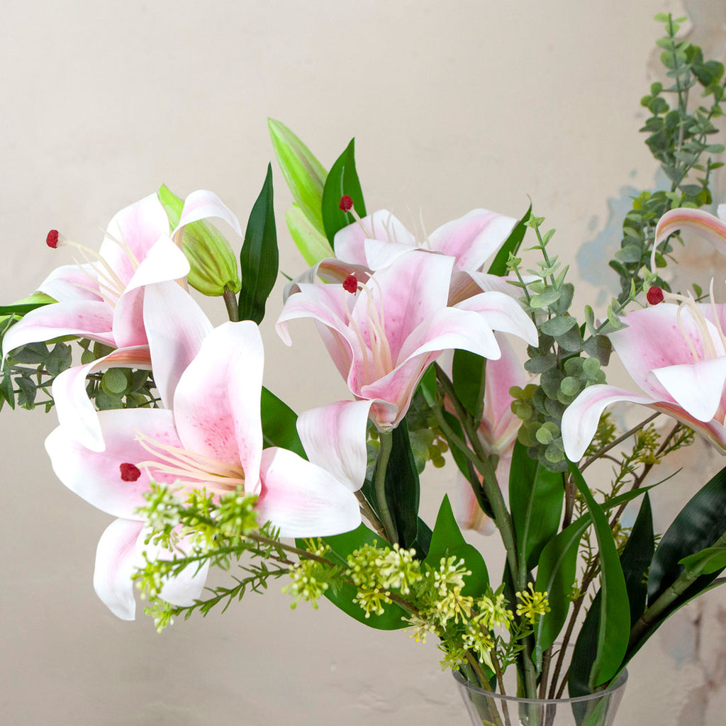 Close up of Casablanca Lilies and Foliage in a Decanter Vase