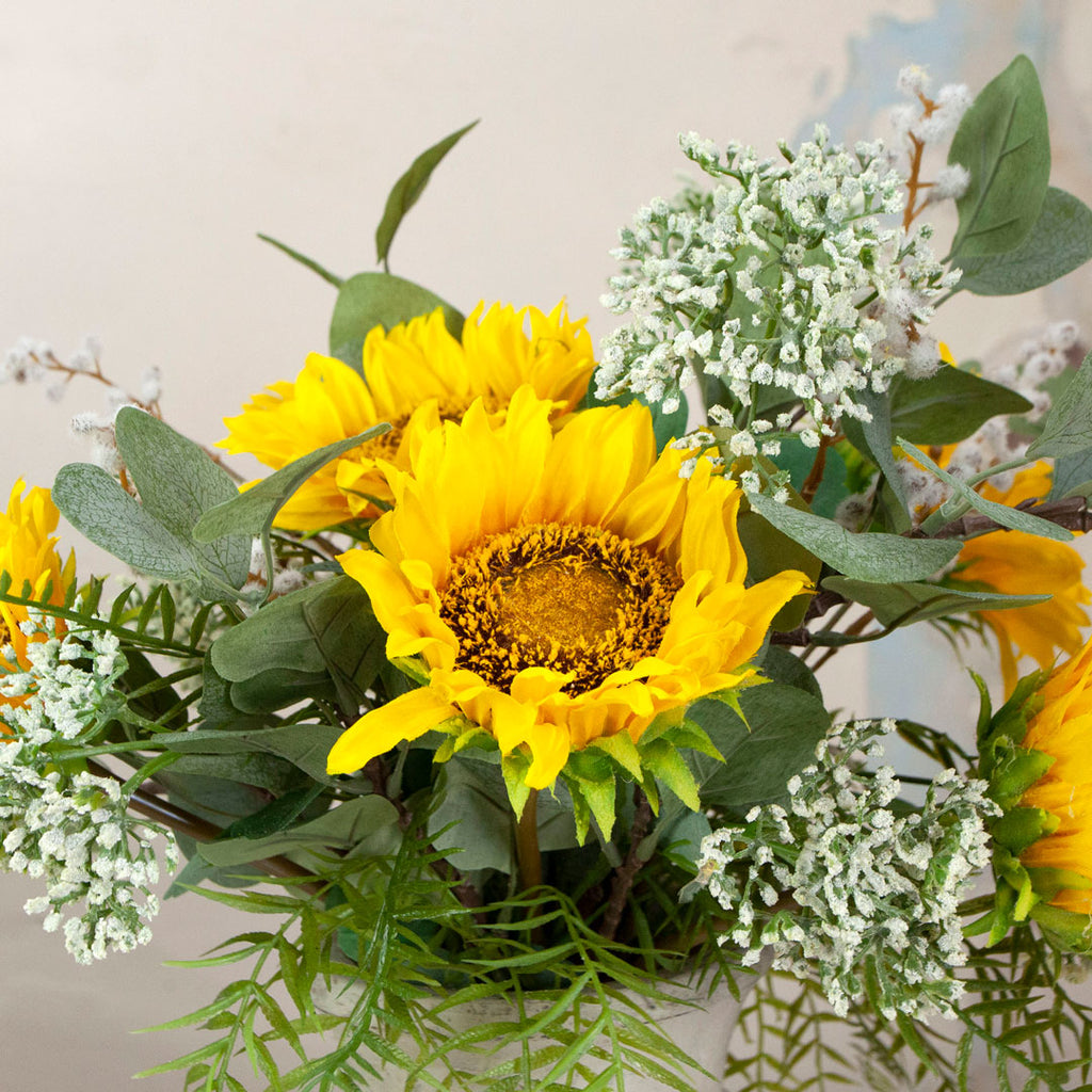 Close up of Sunflower and Foliage in a Rustic Urn