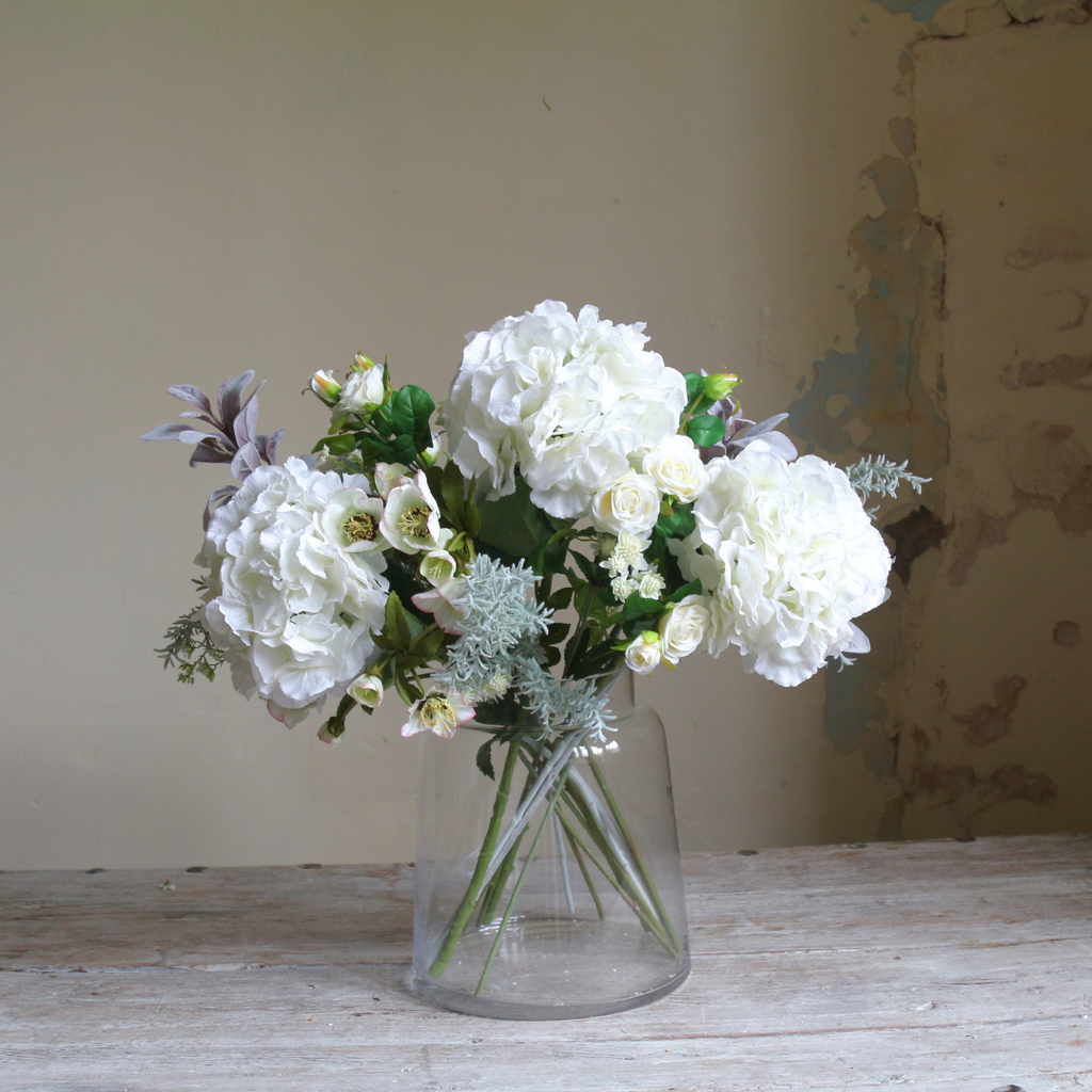 Hydrangeas, Hellebores, and Roses in a Large Chimney Vase