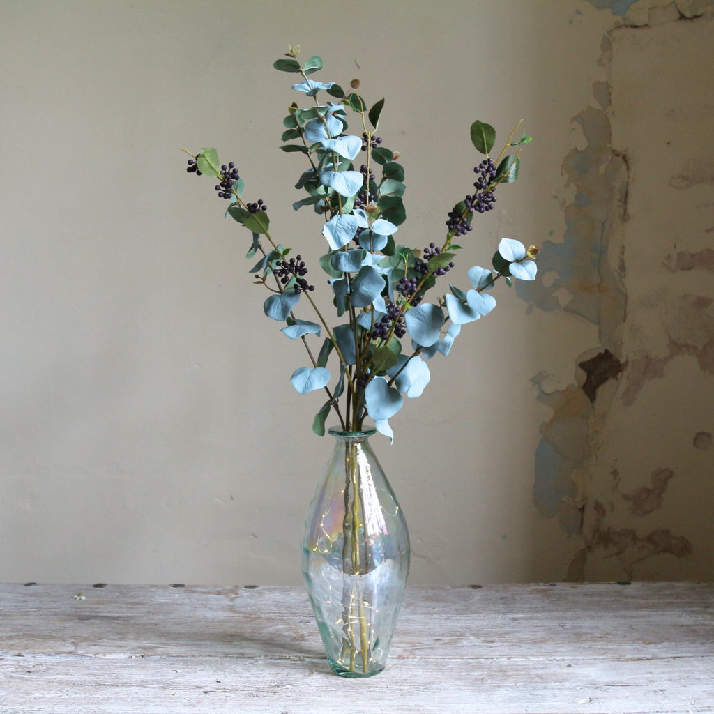 Eucalyptus and Berries in a Tall Lustre Bottle Vase with Rice Lights