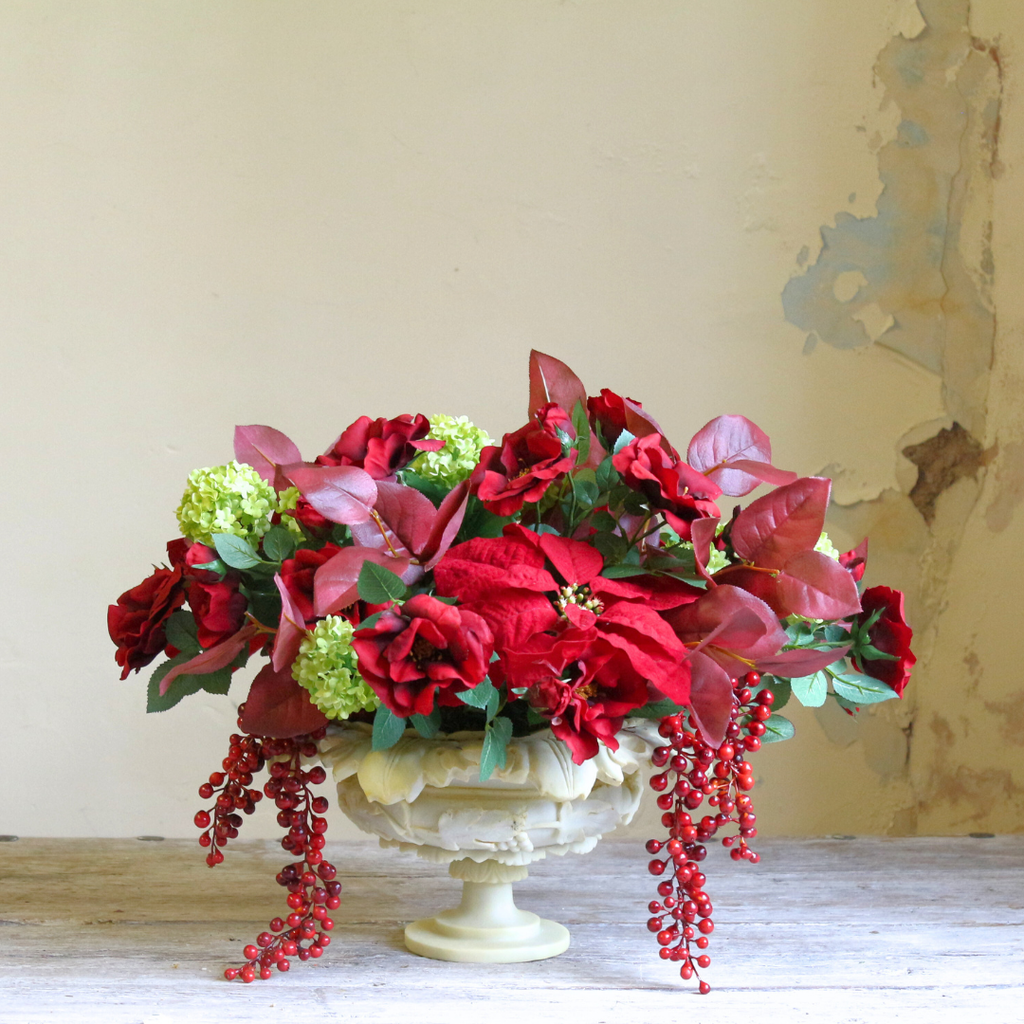 Red Roses and Poinsettias in a Grape Leaf Resin Footed Vase 