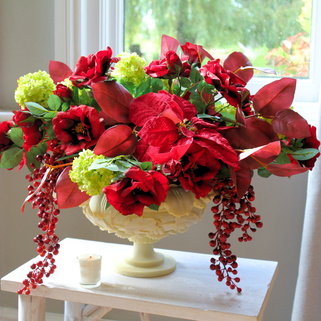 Red Roses and Poinsettias in a Grape Leaf Resin Footed Vase Lifestyle Close up 2