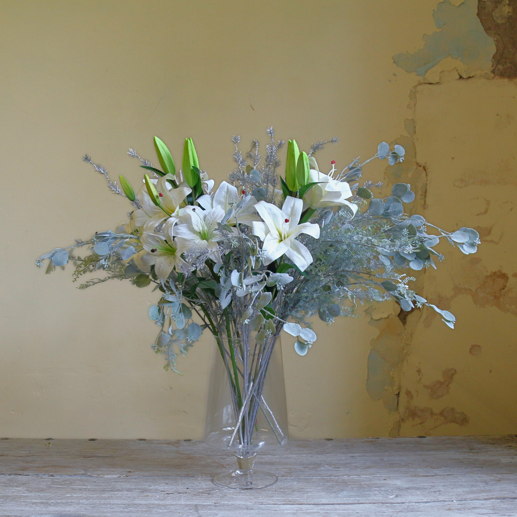 Casablanca Lilies and Silver Eucalyptus Spray in a Large Mouth Blown Glass Vase 