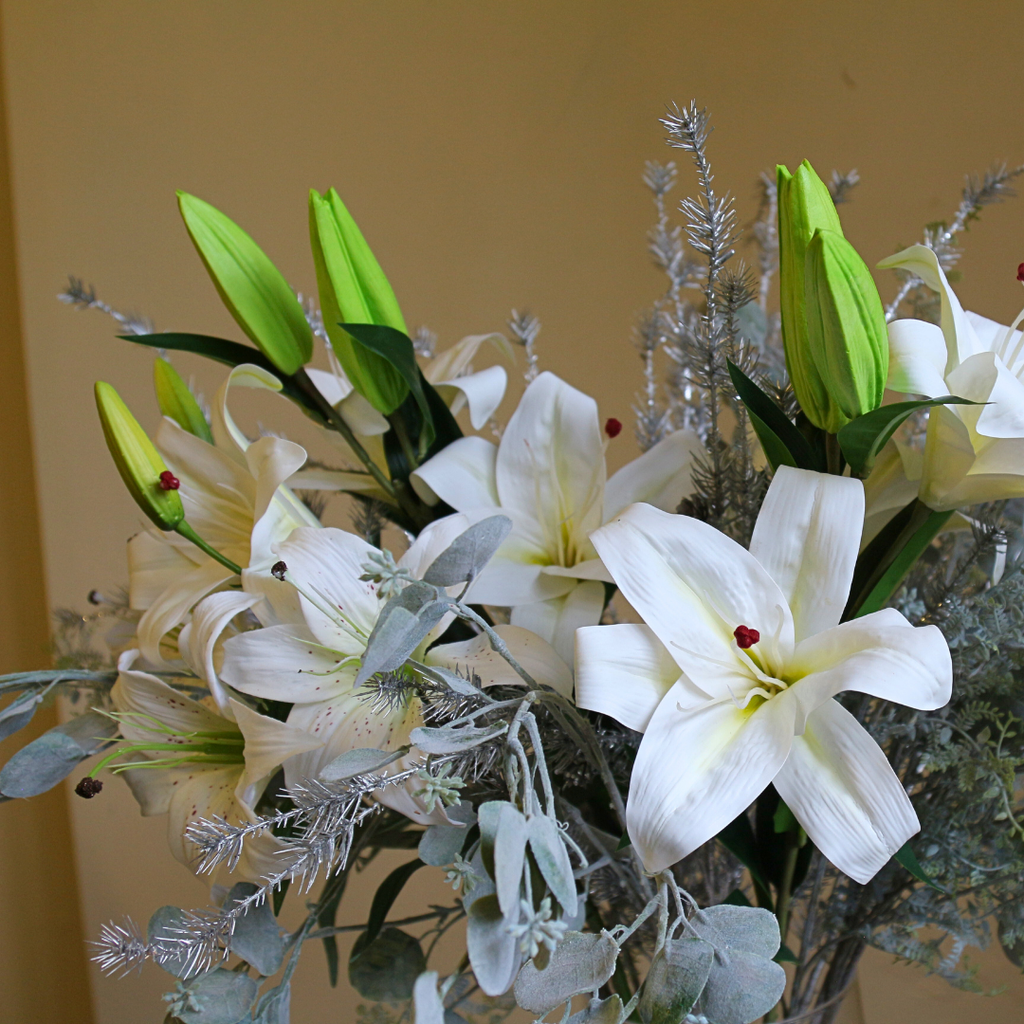 Casablanca Lilies and Silver Eucalyptus Spray in a Large Mouth Blown Glass Vase Close up3