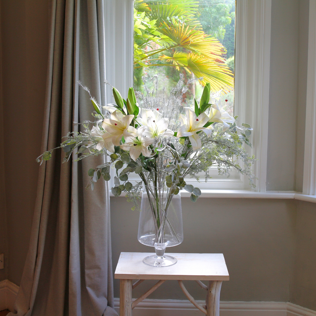 Casablanca Lilies and Silver Eucalyptus Spray in a Large Mouth Blown Glass Vase Lifestyle