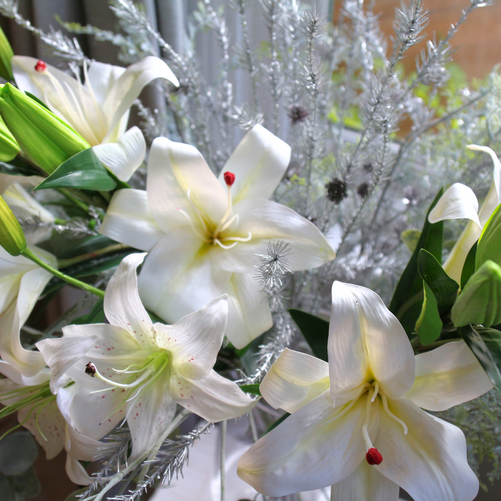 Casablanca Lilies and Silver Eucalyptus Spray in a Large Mouth Blown Glass Vase Lifestyle Close up 