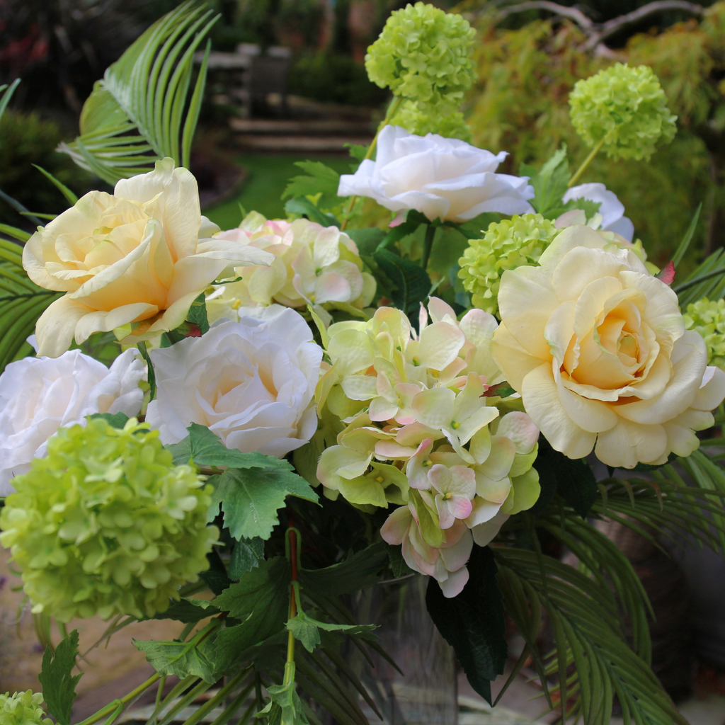 Real Touch Lemon Roses and Areca Palms with Hydrangeas in Footed Smoked Vessel Outside Close up