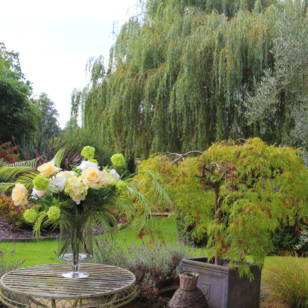 Real Touch Lemon Roses and Areca Palms with Hydrangeas in Footed Smoked Vessel Outside