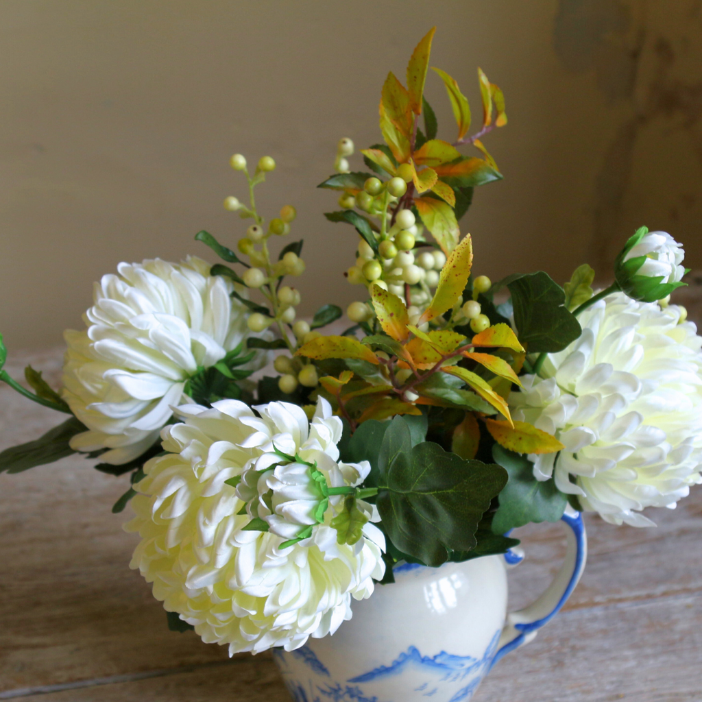 Blue and White Jug with Bridal White Chrysanthemums, Snowberries and Foliage Close up 