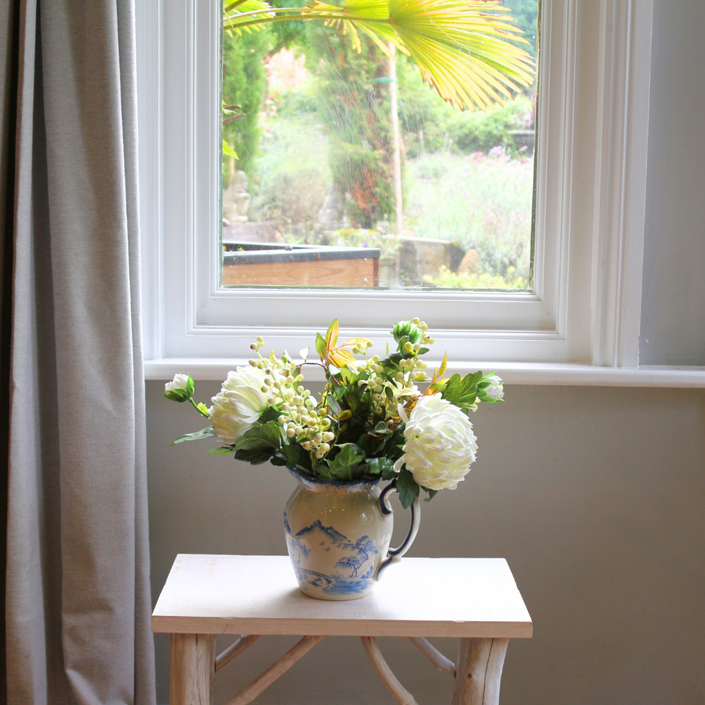 Blue and White Jug with Bridal White Chrysanthemums, Snowberries and Foliage Lifestyle