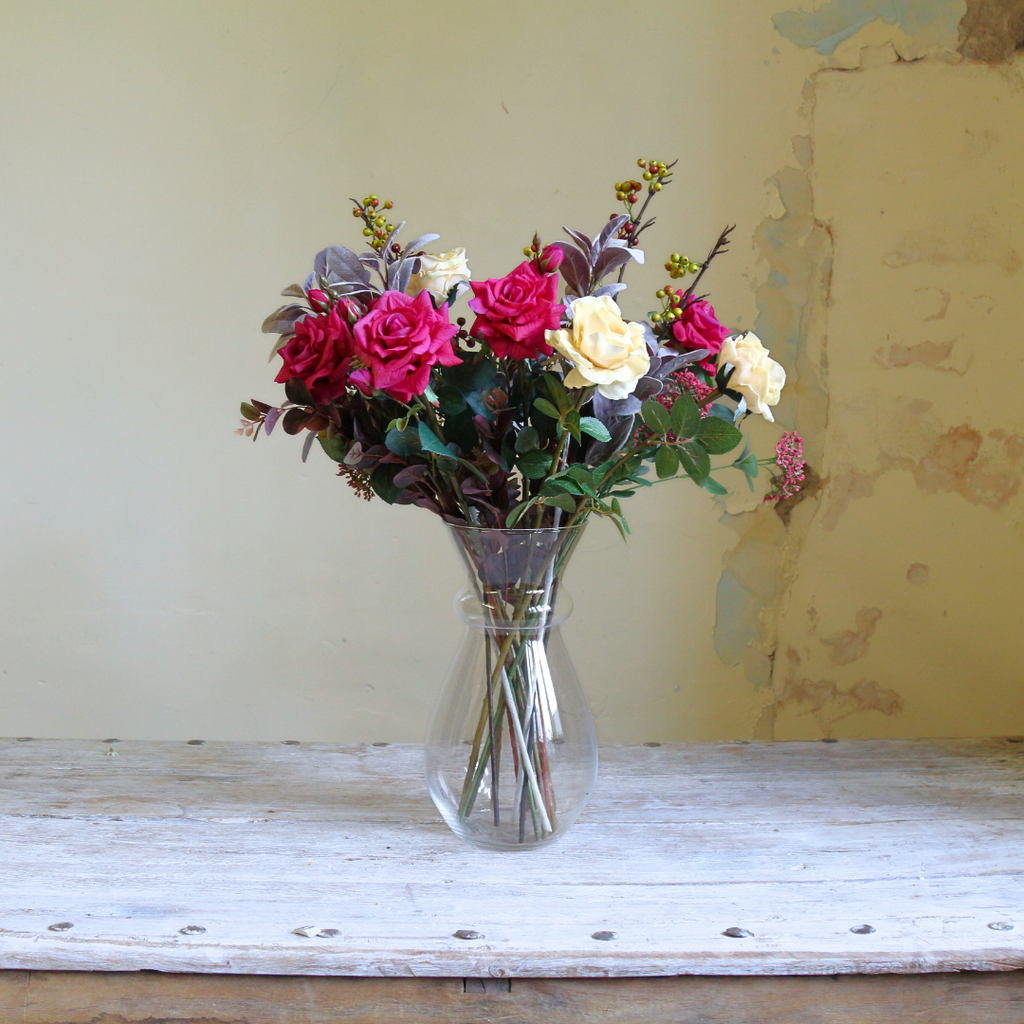 Large Glass Vase filled with breeds of Roses and Foliage