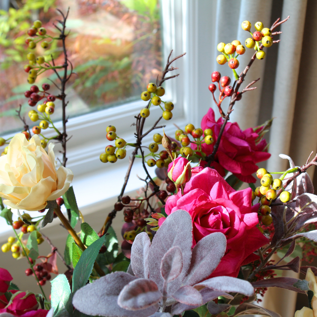 Large Glass Vase filled with breeds of Roses and Foliage lifestyle close up