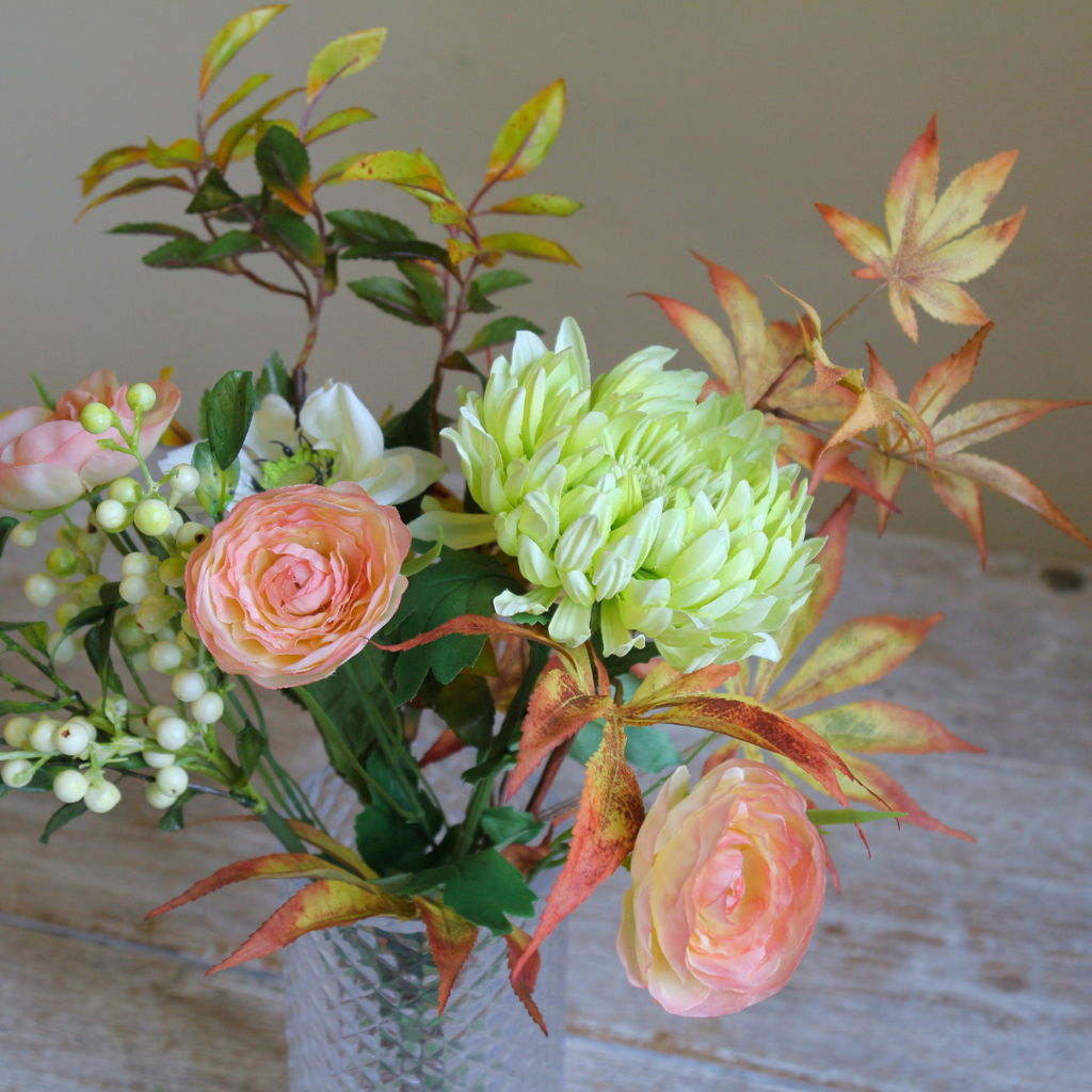 Autumn Mix of Flowers and Foliage in a Pretty Textured Glass Vase Close up