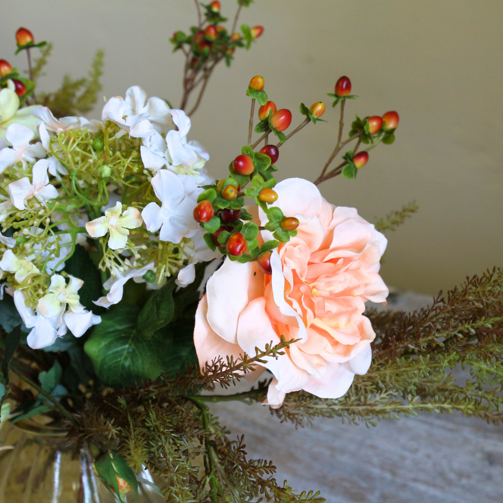 Autumn Mix with Roses, Berries and Hydrangeas in a Amber Pumpkin Vase Close up