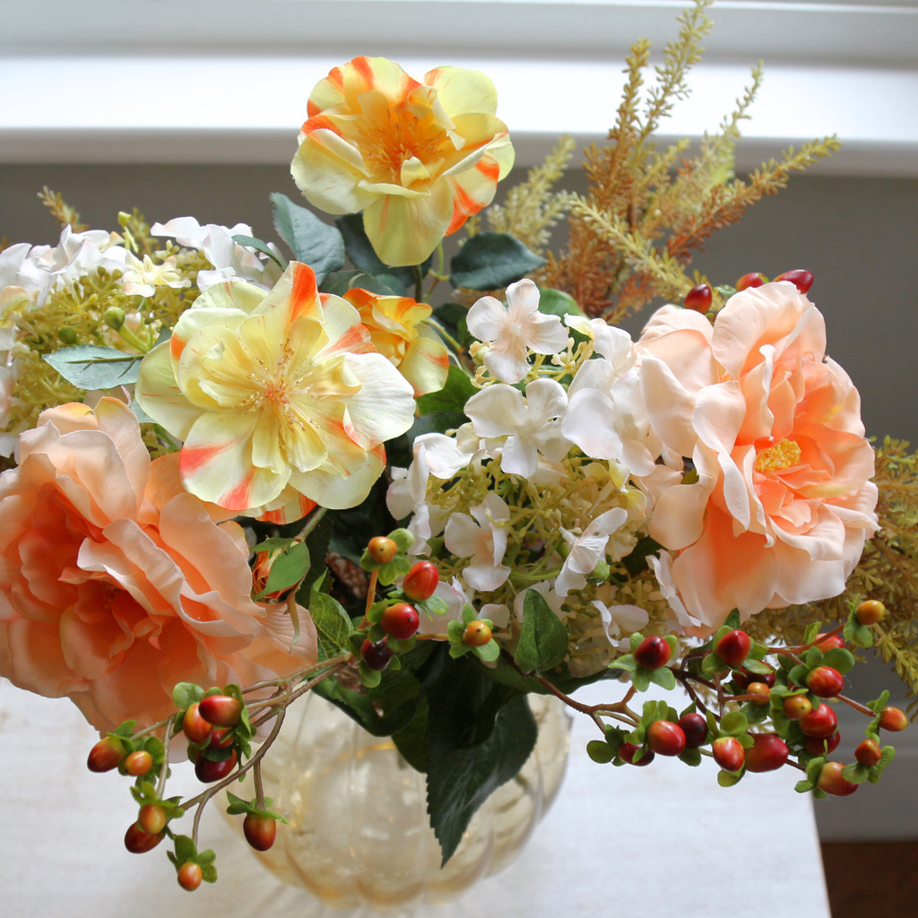 Autumn Mix with Roses, Berries and Hydrangeas in a Amber Pumpkin Vase Lifestyle close up2