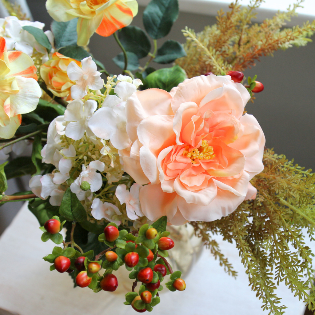 Autumn Mix with Roses, Berries and Hydrangeas in a Amber Pumpkin Vase Lifestyle Close up 3