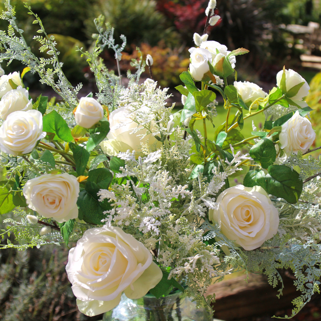 Array of Autumn Blooms, Roses and Pussy Willow in a Glass Vase Outside CLose up