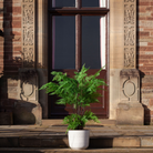 Artificial fern arrangement with lush green fronds displayed in a decorative engraved pot
