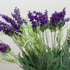 Artificial lavender arrangement with lifelike purple blooms and greenery, potted in a rustic bowl