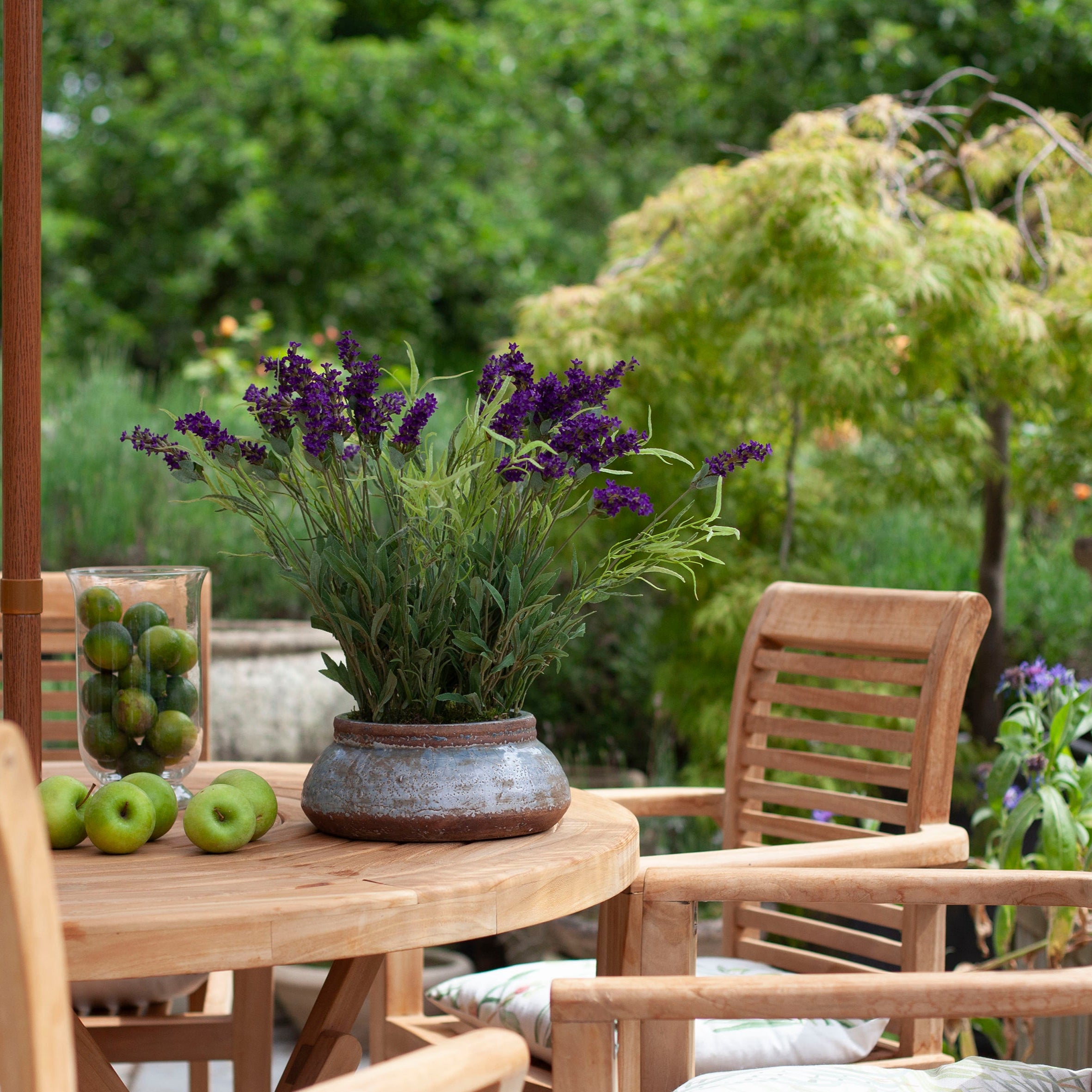 Artificial lavender arrangement with lifelike purple blooms and greenery, potted in a rustic bowl