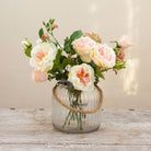 Artficial rose and sweet pea arrangement in a ribbed glass rope lantern vase