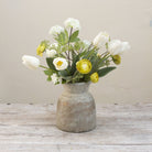 Artificial tulip and ranunculus flower arrangement in a rustic Roman style pot
