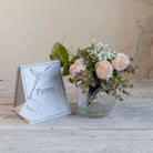 Artificial roses, mini eucalyptus and gypsophila set in a clear optic glass jar vase with Peony gift bag.